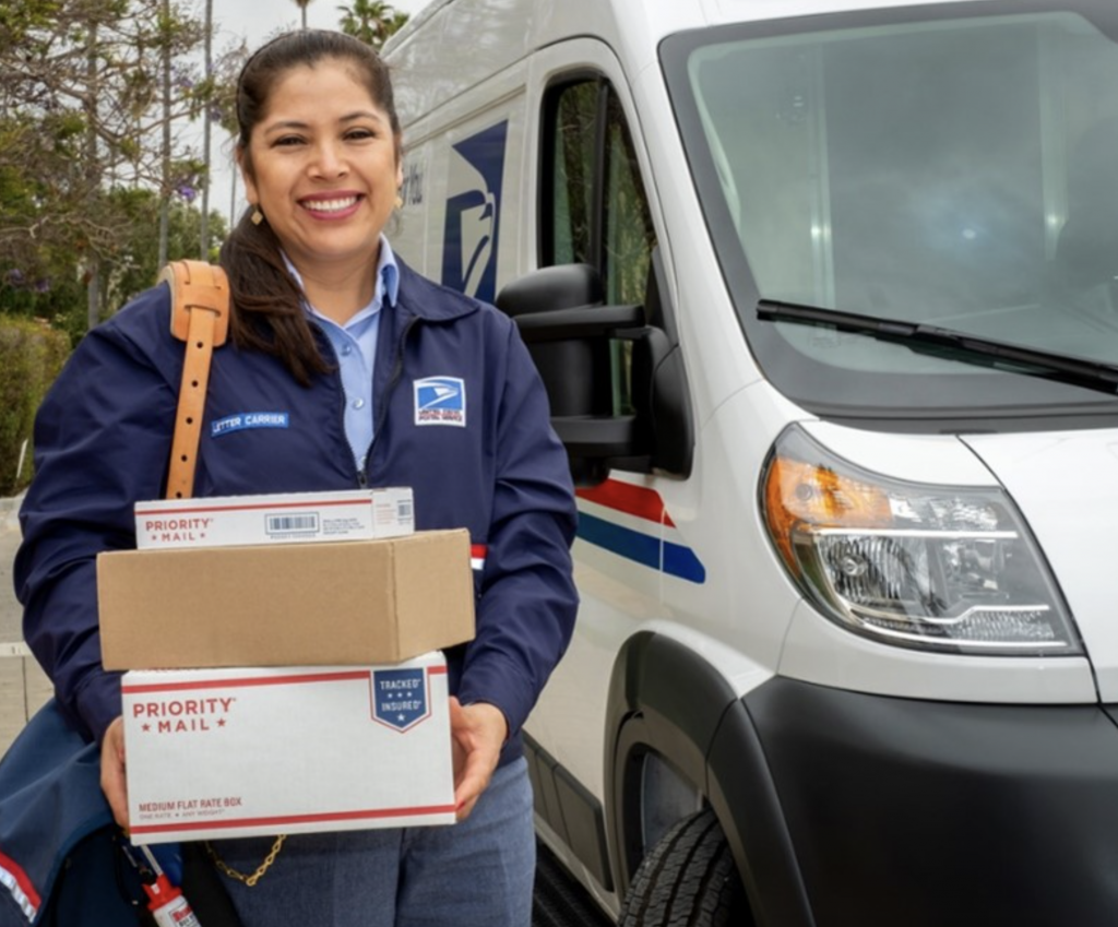 USPS worker holding packages.